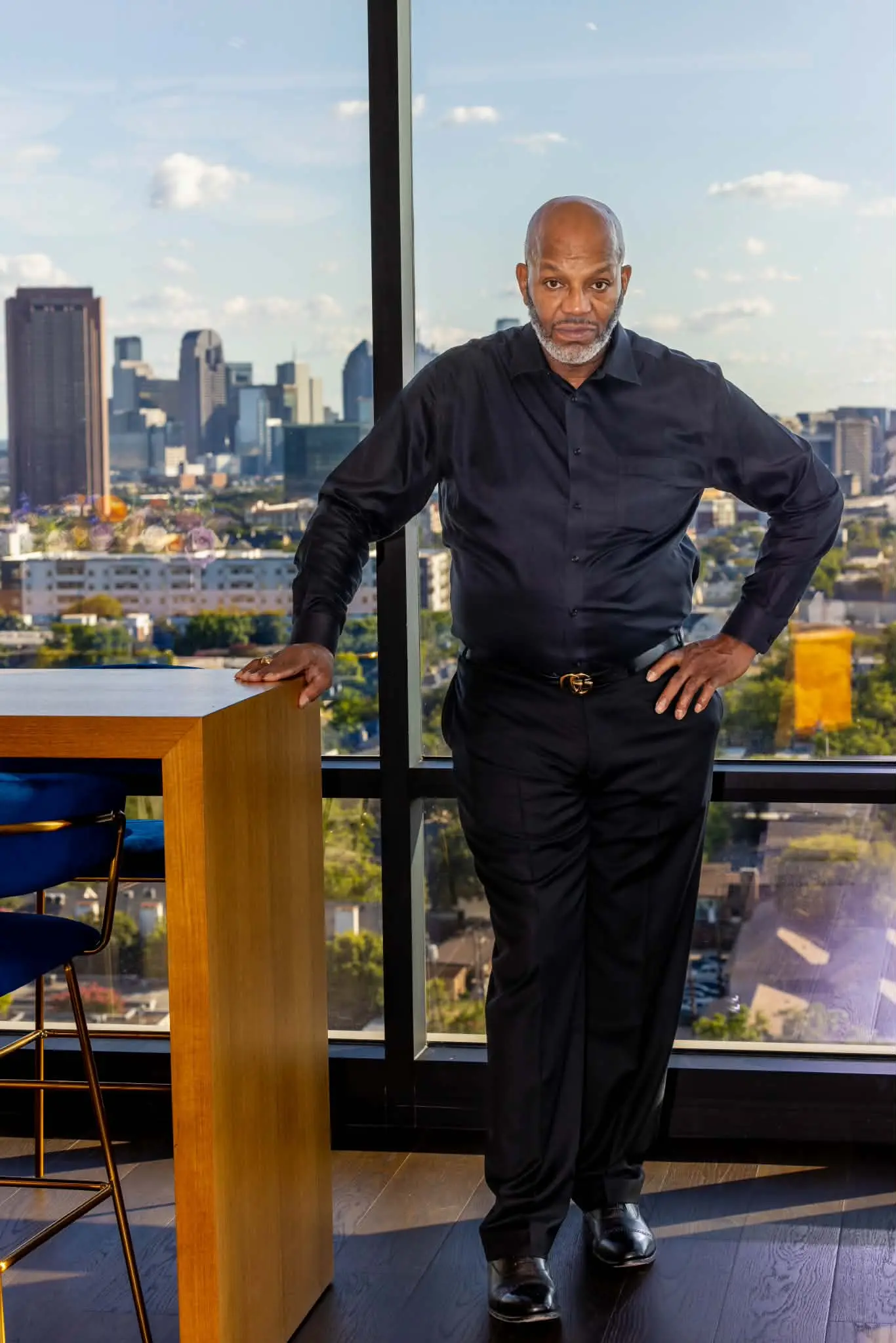 L.A., professional boot and shoe shine specialist, overlooking the Fort Worth skyline